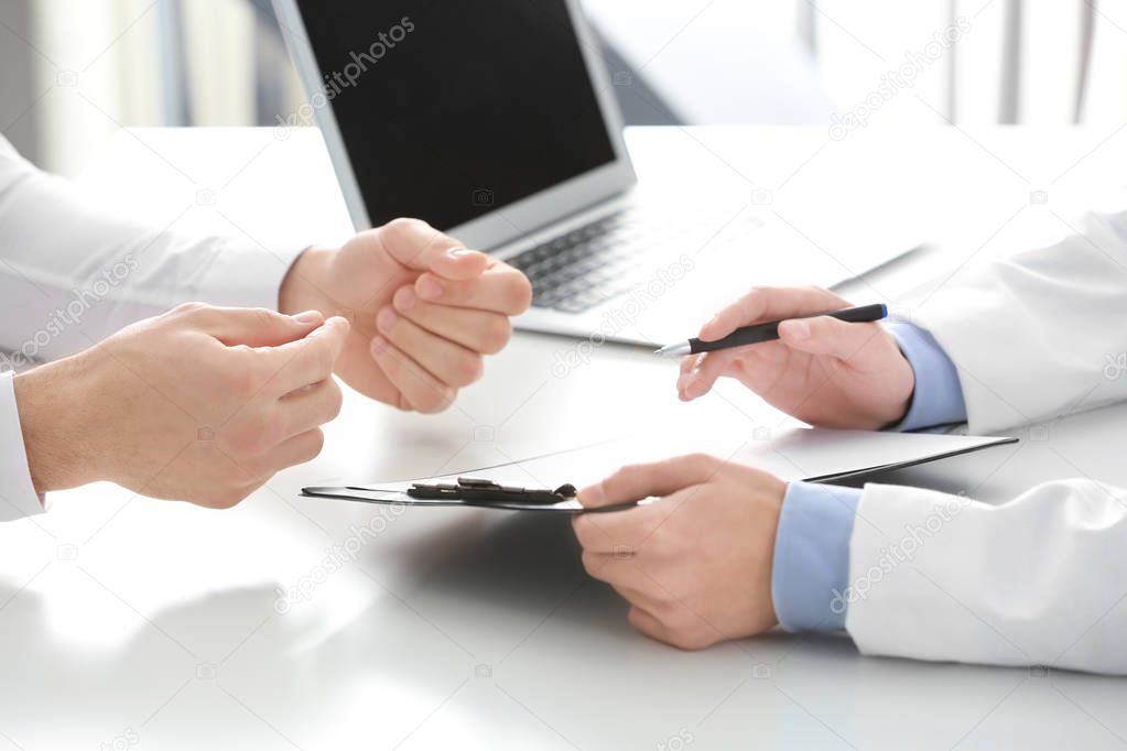 Doctor consulting patient in clinic