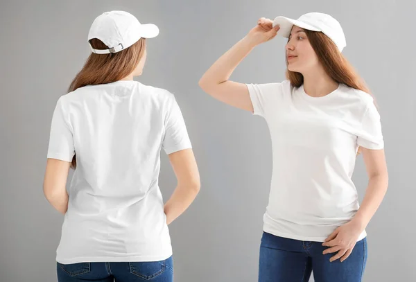 Vista frontal e traseira da jovem mulher em elegante camiseta e boné no fundo cinza. Mockup para design — Fotografia de Stock