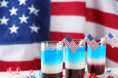 Layered cocktails in colors of American flag on table clipart
