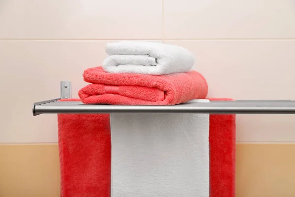 Soft towels on rack indoors — Stock Photo, Image