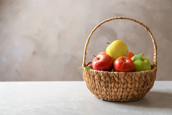 Pommes mûres dans un panier en osier sur la table — Photo