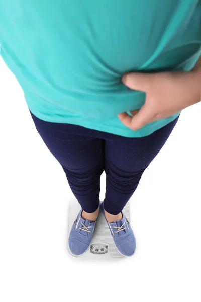 Overweight girl standing on floor scales against white background — Stock Photo, Image