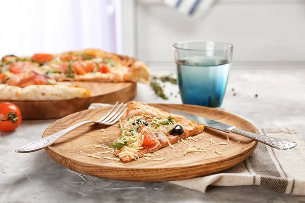 Plato con rebanada de pizza sabrosa en la mesa. Fresco del horno — Foto de Stock