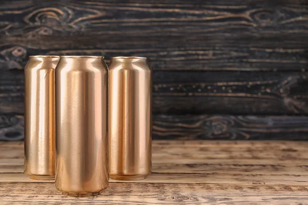 Cans of beer on wooden background