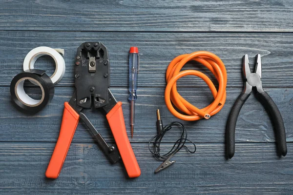 Different electrical tools on wooden background