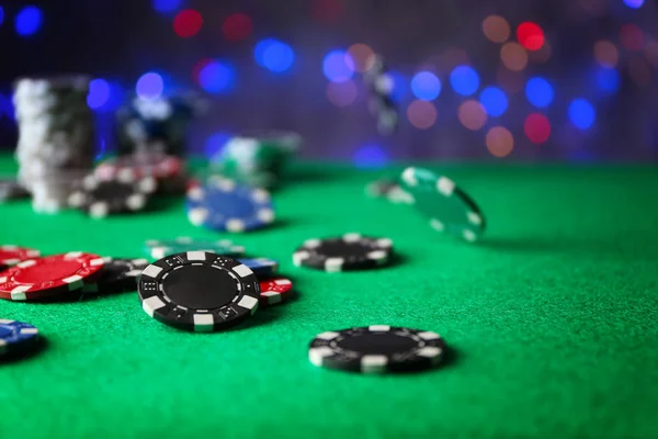 Gambling chips on green table in casino — Stock Photo, Image