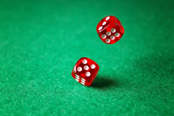 Dices on green table in casino — Stock Photo, Image