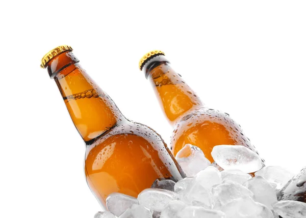 Bottles of beer in ice on white background
