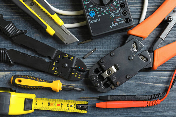 Different electrical tools on wooden background
