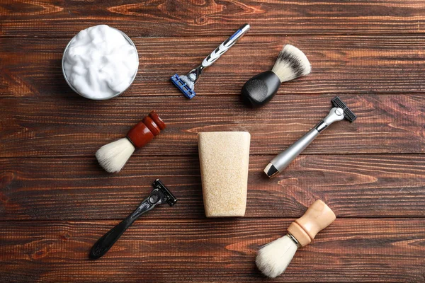 Shaving accessories for man on wooden background