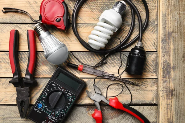 Different electrical tools on wooden background — Stock Photo, Image