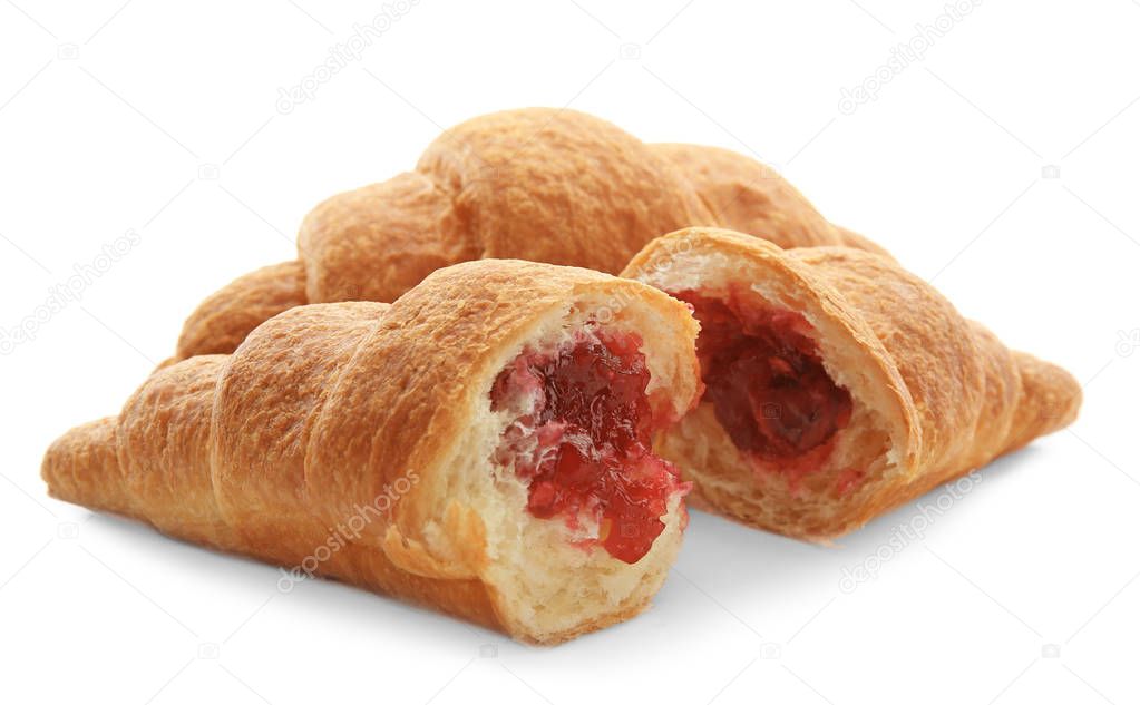 Tasty croissants with jam on white background