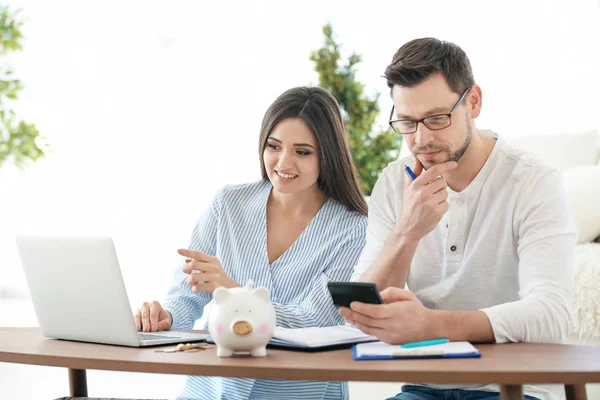 Young couple thinking over pension plan at home — Stock Photo, Image