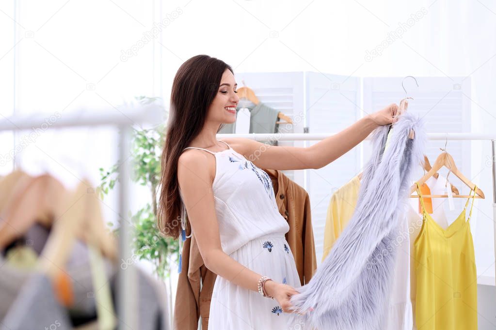 Young beautiful woman shopping in store