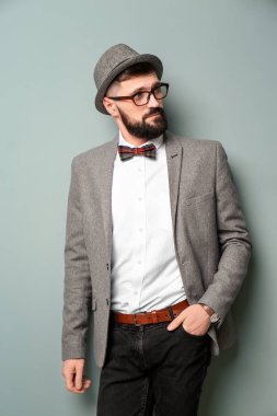Renk arka plan üzerinde şık kıyafeti yakışıklı hipster portresi