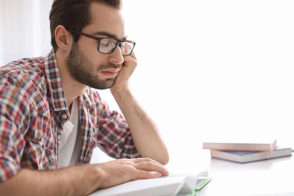 Tired student studying at table indoors — Stock Photo, Image