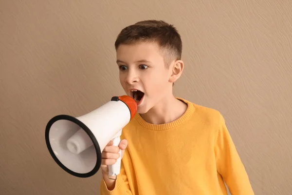 Emotional little boy with megaphone on color background — Stock Photo, Image