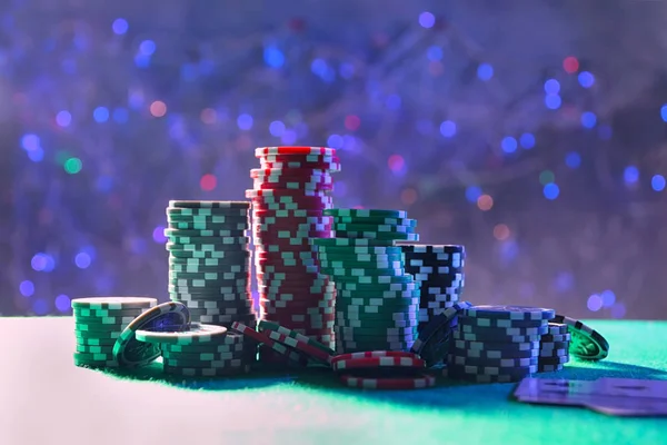 Gambling chips on green table in casino — Stock Photo, Image