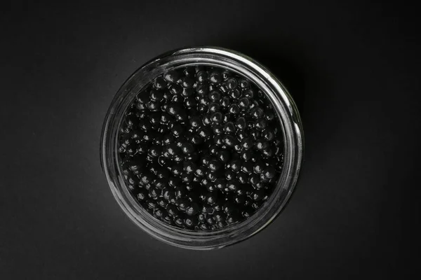 Tarro Con Delicioso Caviar Negro Sobre Fondo Oscuro —  Fotos de Stock