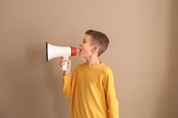 Funny little boy with megaphone on color background — Stock Photo, Image