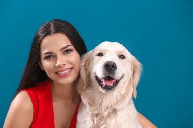 Genç kadın ile köpek renk arka plan üzerinde. Evde beslenen hayvan ve sahibi arasındaki dostluk