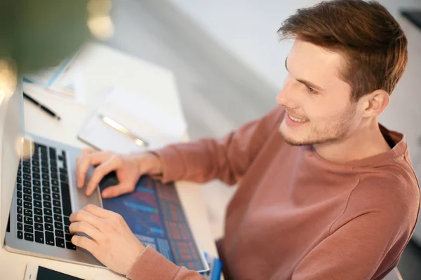 Jeune homme travaillant avec ordinateur portable à l'intérieur — Photo