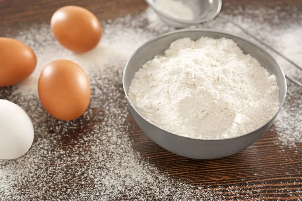 Bowl Wheat Flour Raw Eggs Wooden Table — Stock Photo, Image