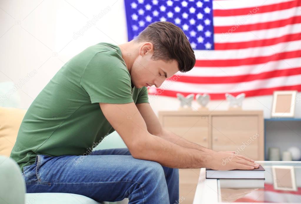 Man with Bible praying for America at home