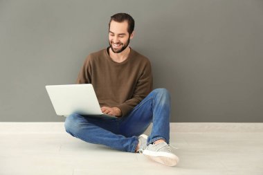 Genç adam dizüstü bilgisayar kullanıyor