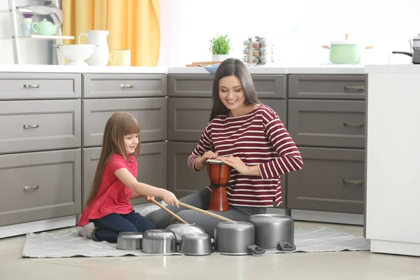Mother and daughter playing drums