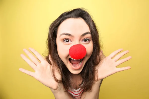 Young woman in funny disguise on color background. April fool's day celebration — Stock Photo, Image