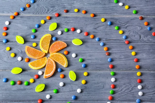 Colorful candies on wooden table — Stock Photo, Image