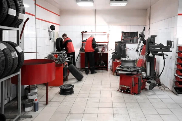 Mechanics working in tire store