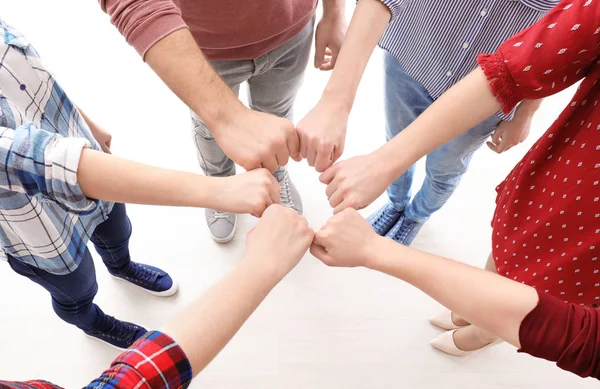 Young people putting fists together — Stock Photo, Image