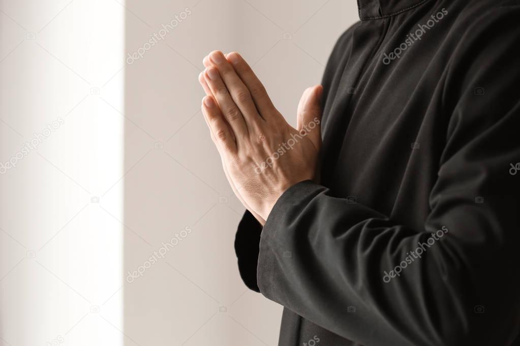 priest praying to God 