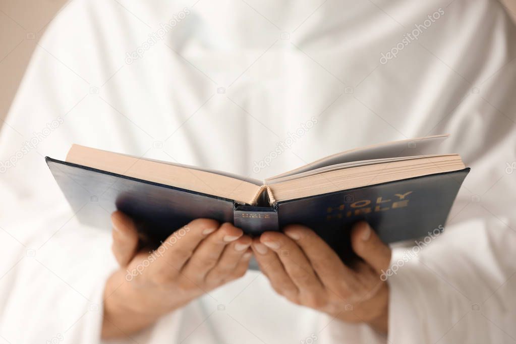 Young monk reading Bible