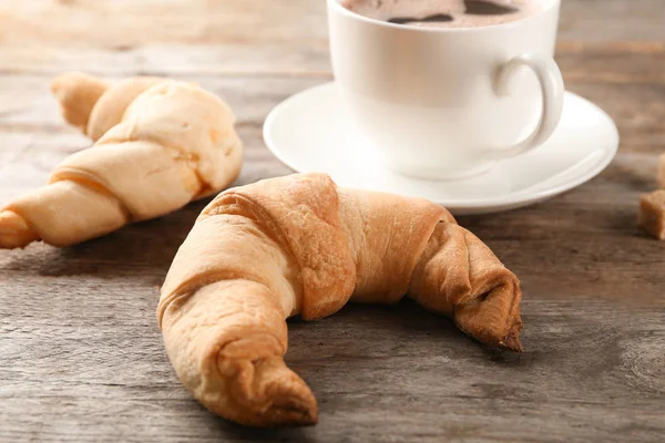 Tasty crescent rolls and coffee — Stock Photo, Image