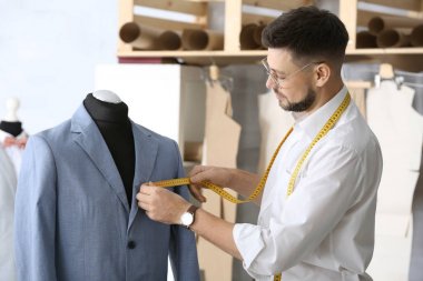 Atelier manken üzerinde ceket ölçümleri alarak terzi