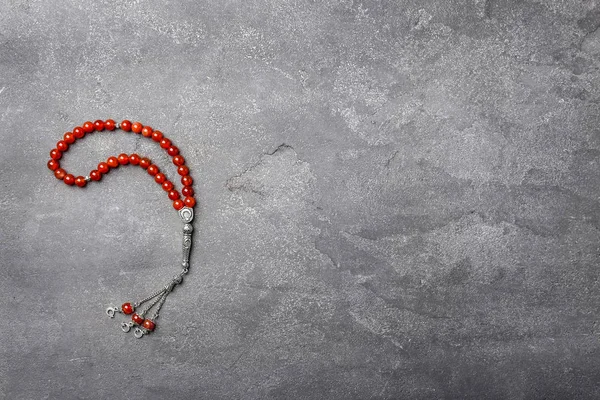 Muslim prayer beads on gray background — Stock Photo, Image