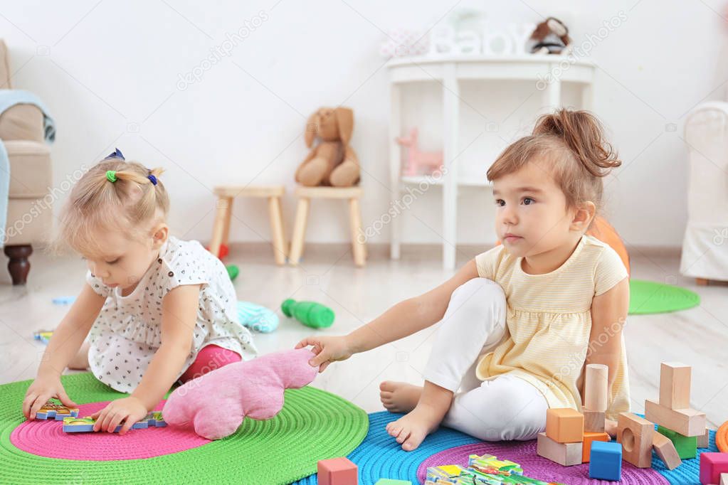 Adorable little children playing indoors
