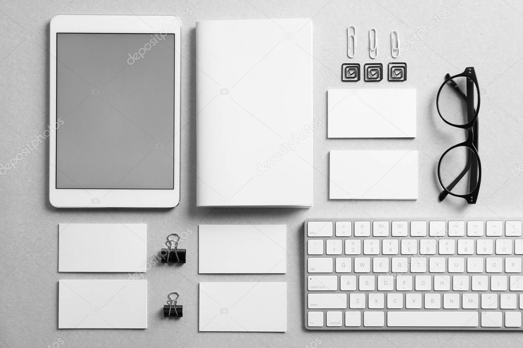 Set of devices and stationery on grey background