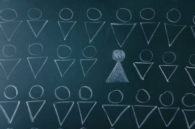 Chalkboard with human figures and one different