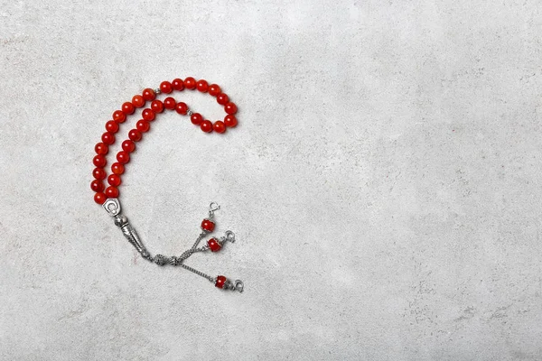 Muslim prayer beads on gray background — Stock Photo, Image