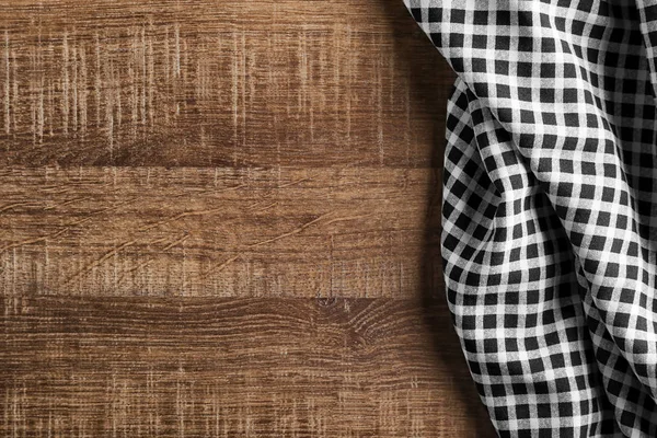 Tekstil kotak-kotak dengan latar belakang kayu. Tekstur kain — Stok Foto
