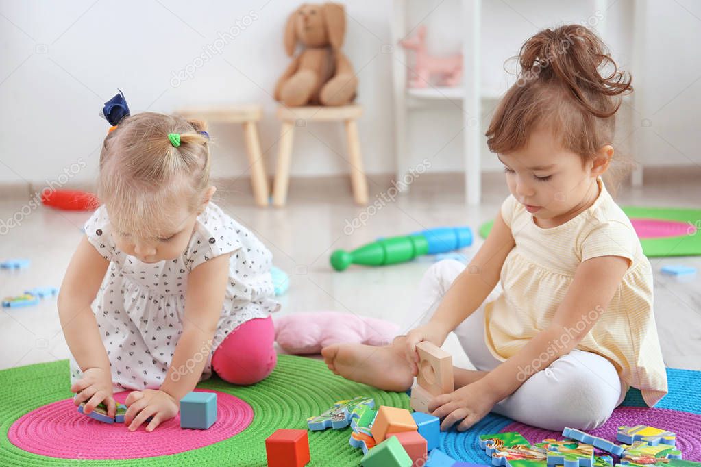 Adorable little children playing indoors