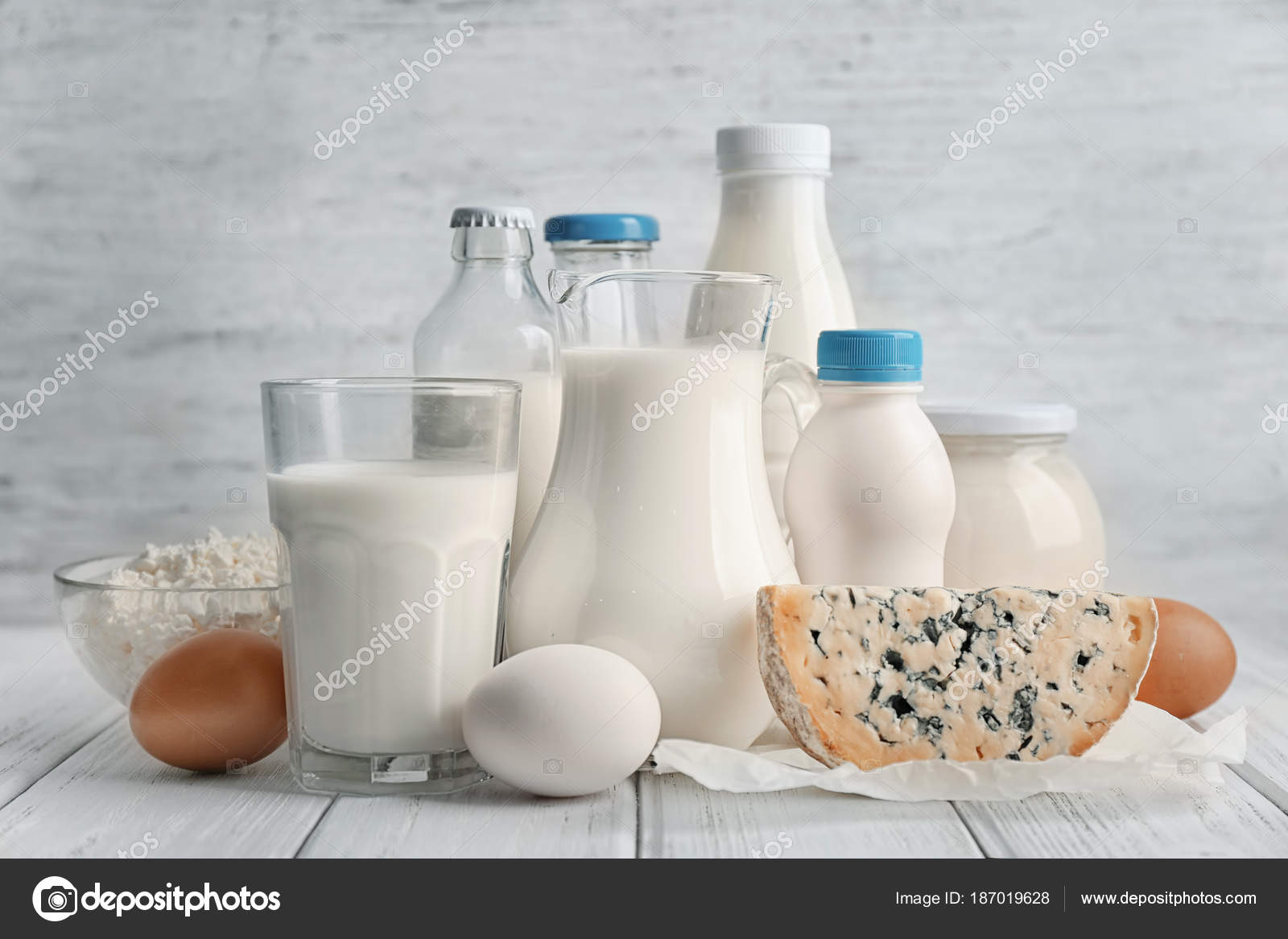 Different dairy products and eggs on table Stock Photo by ©belchonock