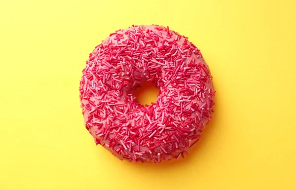 Delicioso donut rosa no fundo da cor — Fotografia de Stock