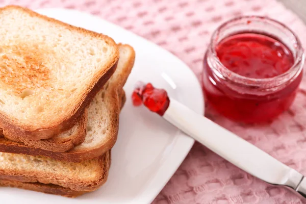 Plate with toasted bread and jam on table — Stock Photo, Image