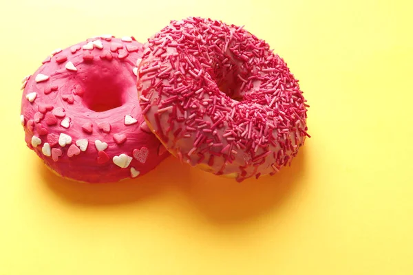 Delicious pink donuts on color background — Stock Photo, Image