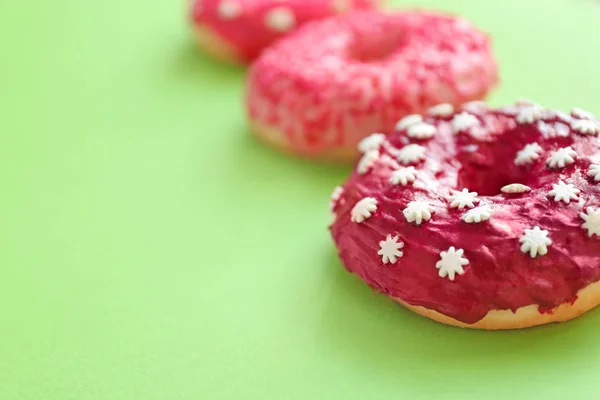 Delicious donuts on color background — Stock Photo, Image